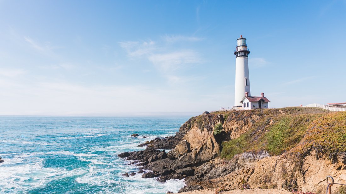 Lighthouse on a hill by the sea